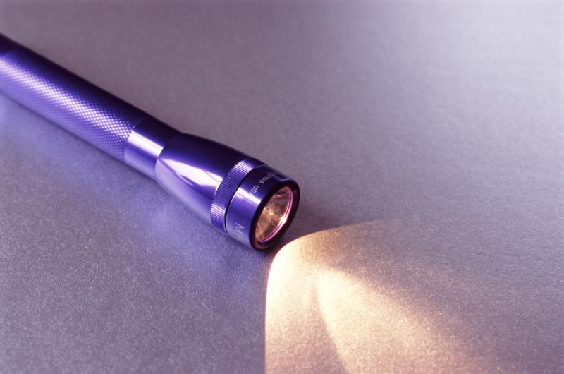 Free Stock Photo: a purple coloured torch or flashlight with light shining out of the front