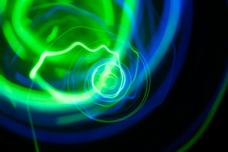 Free Stock Photo: random spiralling green and blue trails of light vanishing to a central point