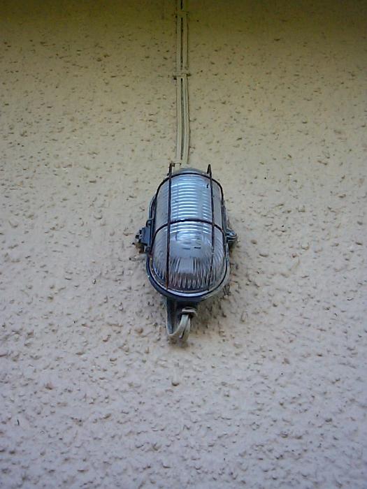 Free Stock Photo: bulkhead lamp mounted on a render wall