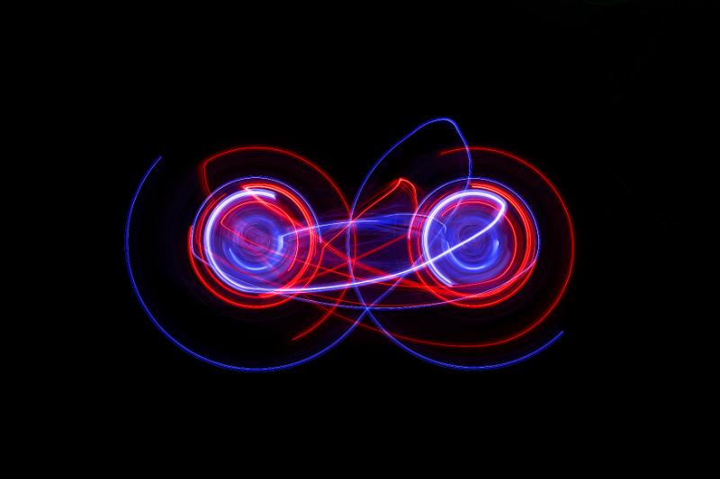 Free Stock Photo: lightpainting background featuring two interlinked circles of light with vibrant red and blue streaks