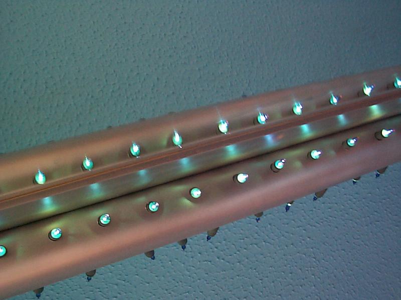 Free Stock Photo: a strip of blue lights on a silver frame with blue wall behind
