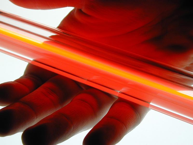 Free Stock Photo: a red coloured neon tube resting in an open hand