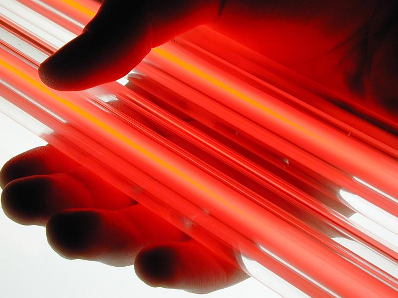 Free Stock Photo: two vibrant red neon tubes held in a hand