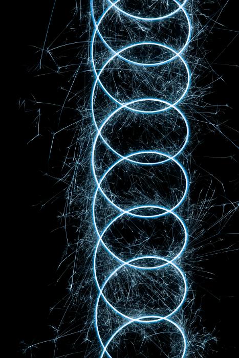 Free Stock Photo: swirls of blue coloured sparks plotting a mathematical trochoid pattern on a dark background