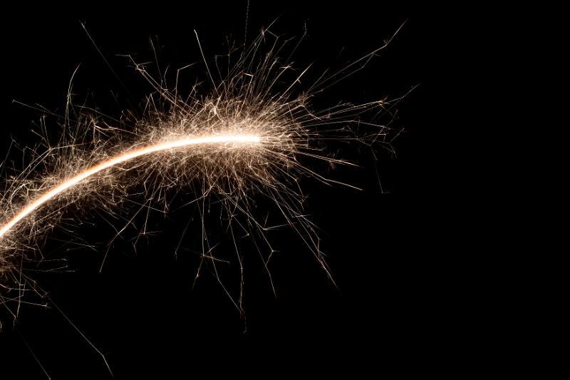 Free Stock Photo: an arching trail of hot glowing sparks on a black backdrop