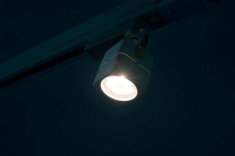 Free Stock Photo: a single lit halogen track spotlight in a darkend room