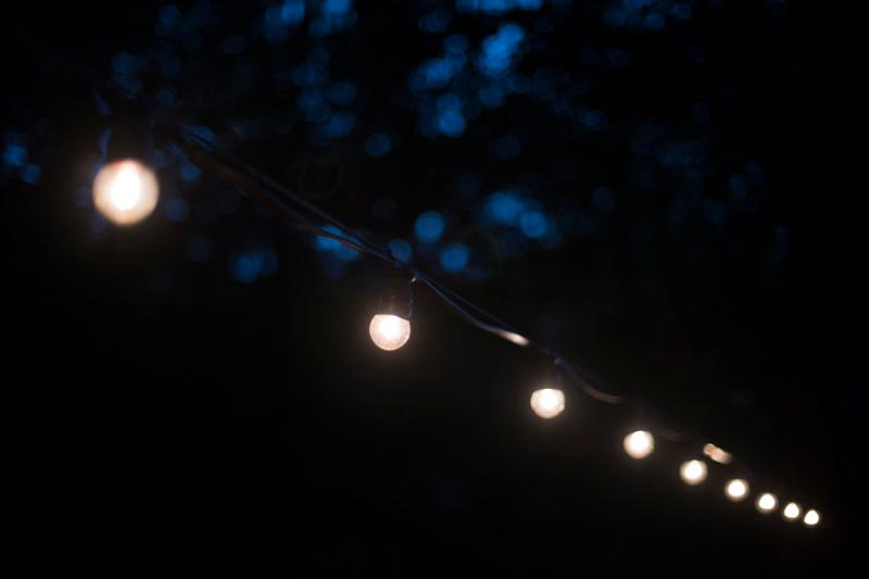 Free Stock Photo: a night time view of a string of outdoor festoon party lights with white bulbs