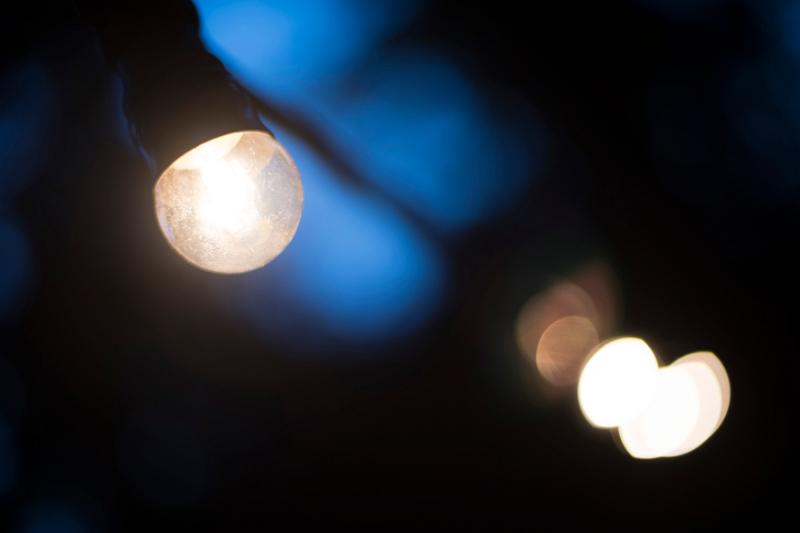 Free Stock Photo: closeup on a bulb in a white outdoor string of lights