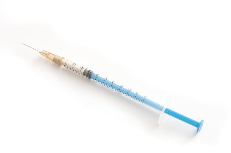 Free Stock Photo: High Angle View of Syringe Filled with Injectable Medication Angled on White Background