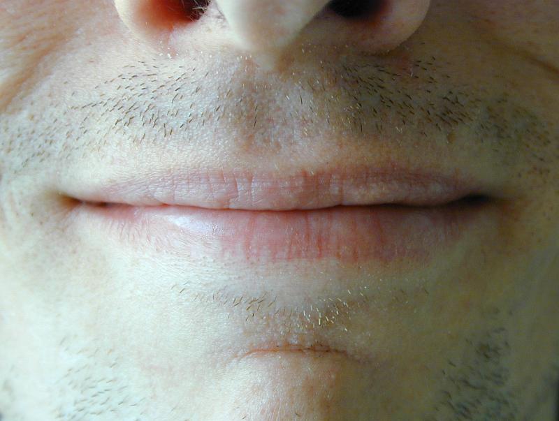 Free Stock Photo: Close up of the smile of a man with unshaven stubble