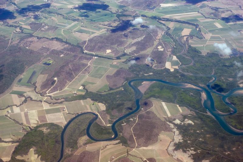 Free Stock Photo: Aerial view of a riverine estuary and floodplain winding through fertile agricultural land and fields