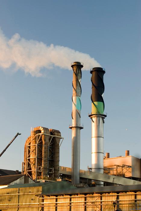 Free Stock Photo: Industrial chimney at a factory or manufacturing plant emitting smoke into the air causing atmospheric pollution