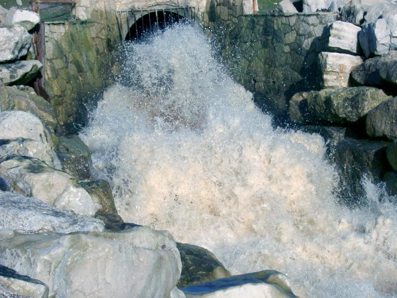 Free Stock Photo: Water gushing out of a cement pipe into a spillway in a white torrent, probably either a stormwater outlet or overflow