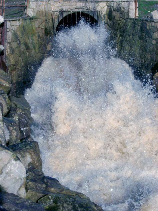 Free Stock Photo: White frothy water gushing from a stormwater culvert with great force into a channel during flooding