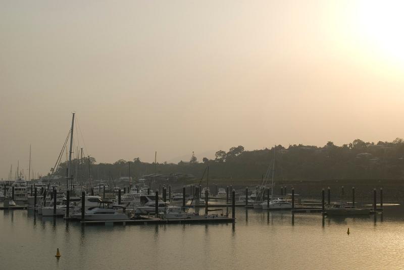 Free Stock Photo: Poor air quality as the sun tries to shine through a low lying haze of smog and photochemical pollution over a coastal marina