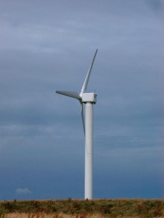 Free Stock Photo: Alternative wind energy with a tall aeolian or wind turbine on a hilltop which converts the kinetic energy of the wind to electrical energy