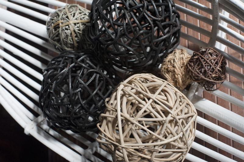 Free Stock Photo: Selection of different hand crafted wicker ball decorations on a Venetian blind in front of a brick wall