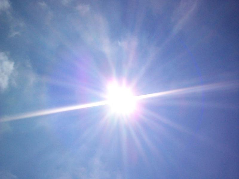 Free Stock Photo: Sunburst in a blue sky with multiple clearly defined rays and genuine lens flare