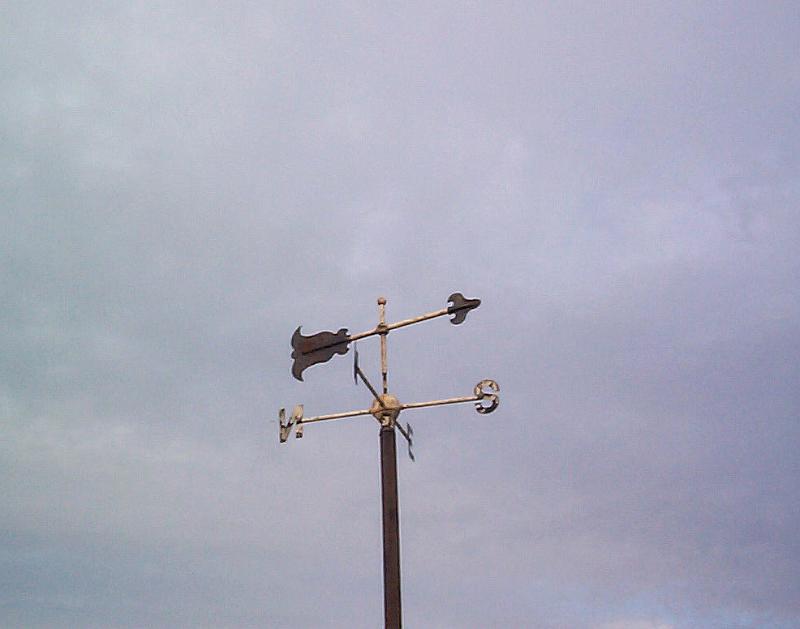 Free Stock Photo: Low Angle View of Decorative Weather Vane Pointing Towards South and Shot Against Cloudy Overcast Sky