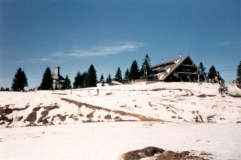 Free Stock Photo: Hilltop Chalet at Mountain Ski Resort with Chair Lift on Sunny Day During Early or Late Season with Sparse Snow Cover