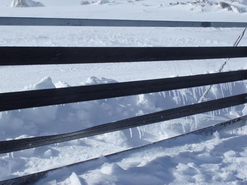 Free Stock Photo: icicles forming on a mountain top snowdrift fence