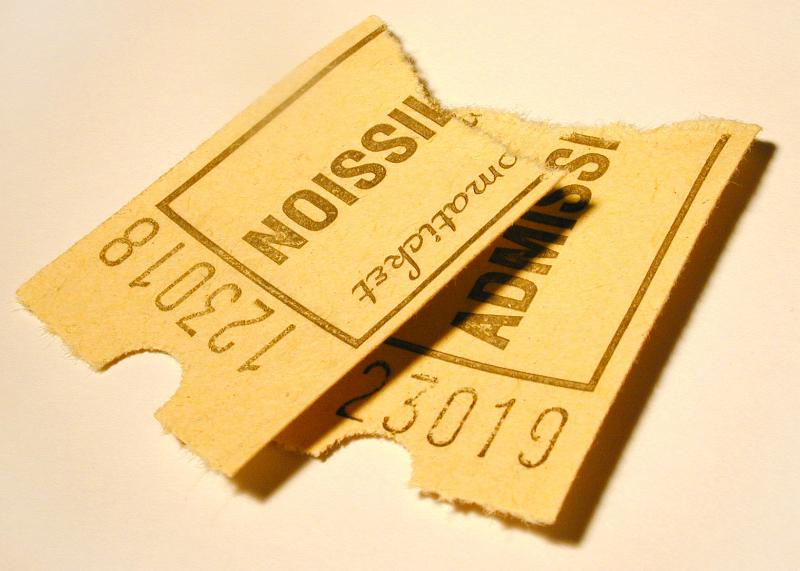 Free Stock Photo: Two stubs of admission tickets of yellow paper with numbers, viewed in close-up