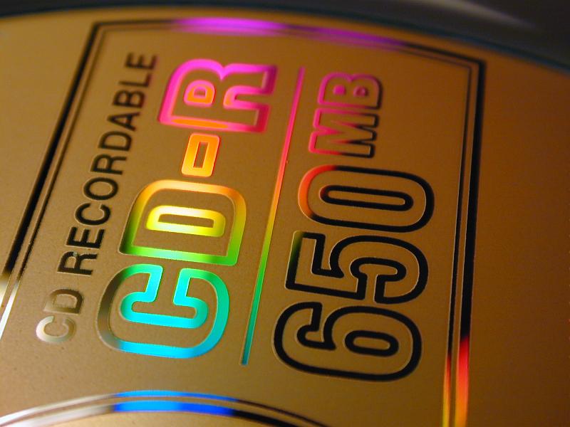 Free Stock Photo: Close up on a 650mb CD-R recordable compact disk showing the rainbow colored reflection of the metallic text