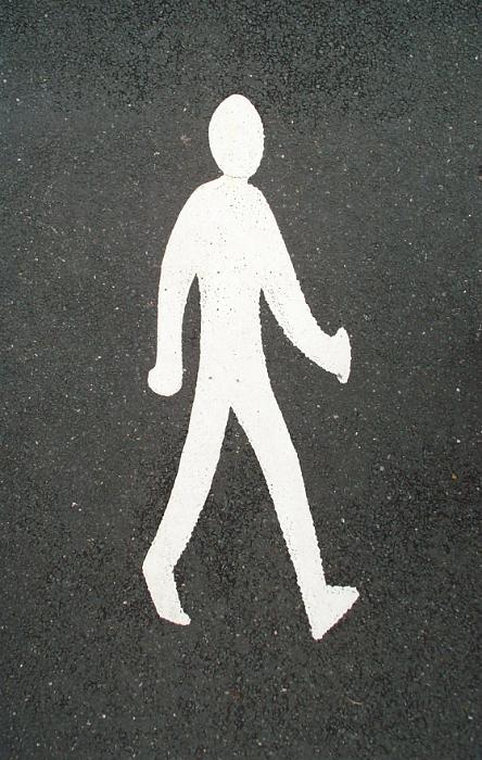 Free Stock Photo: Pedestrian street crossing with a white sign of a walking man painted on asphalt viewed from above