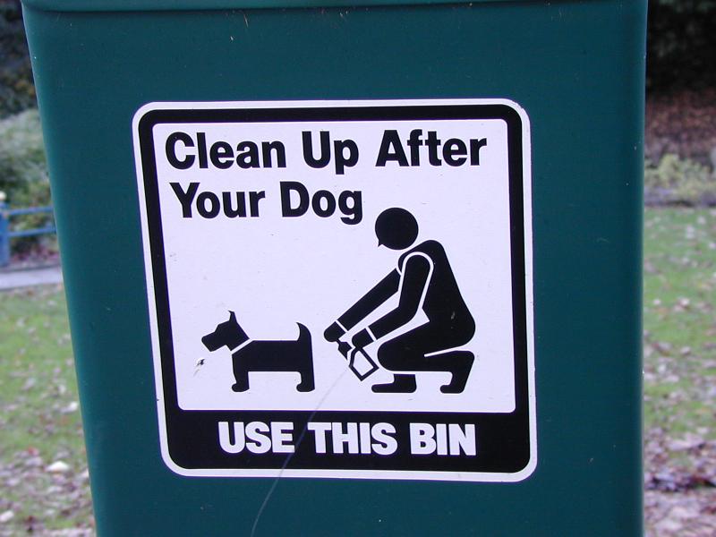 Free Stock Photo: Clean Up After Your Dog black and white sign in park on plastic bin in close-up with dog and owner pictogram