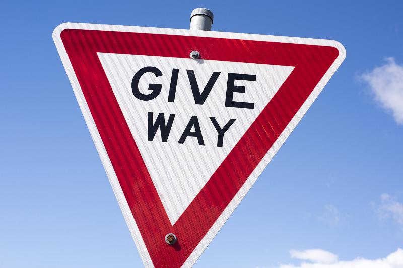 Free Stock Photo: Traffic warning triangle - Give Way - or yield against a sunny blue sky close up