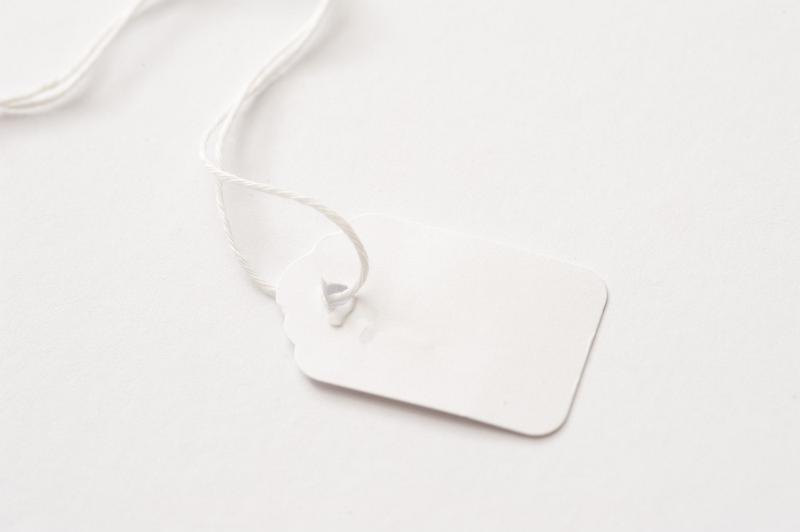 Free Stock Photo: A close up of a blank white price tag on a white background with copy space.