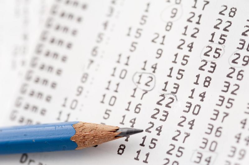 Free Stock Photo: Lottery ticket or draw card and pencil with rows of numbers and focus to the nib