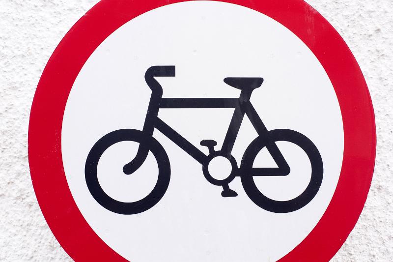 Free Stock Photo: No Bicycles forbidding road sign with black image of a bicycle on white background inside the red circle, viewed cropped in close-up