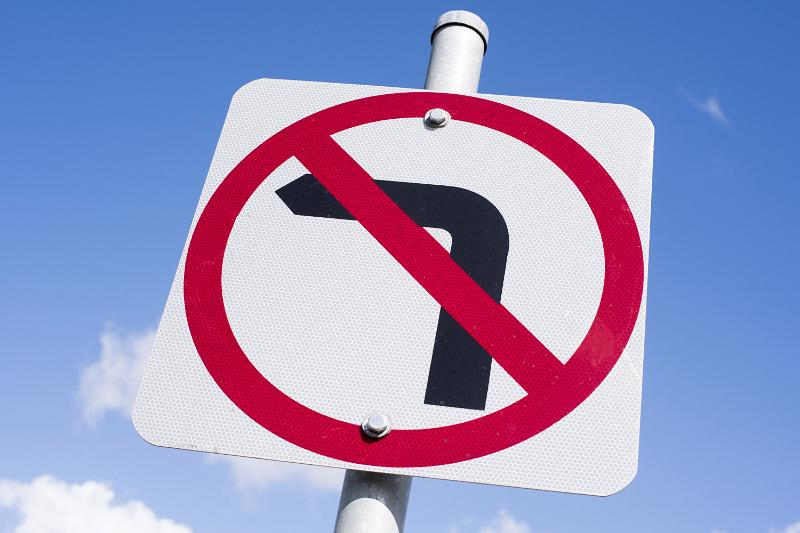 Free Stock Photo: No Left Turn traffic street sign against blue sky in a close up low angle view