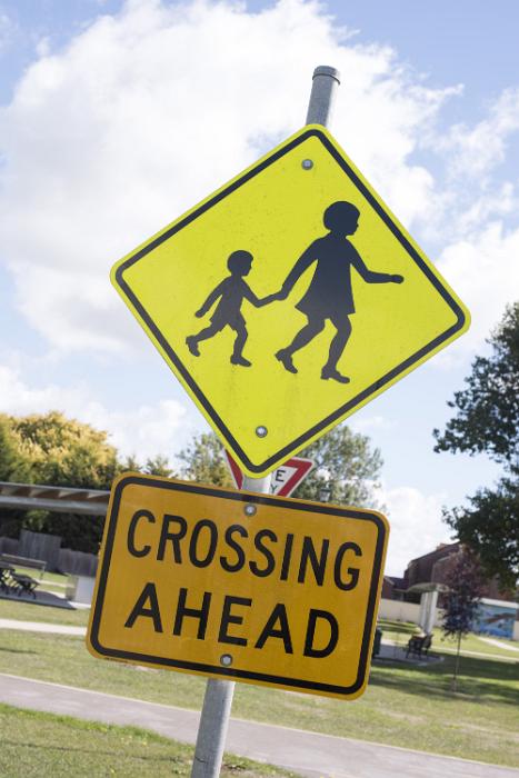 Free Stock Photo: Pedestrian Crossing sign with children on a street warning traffic of an approaching crossing in a town or village