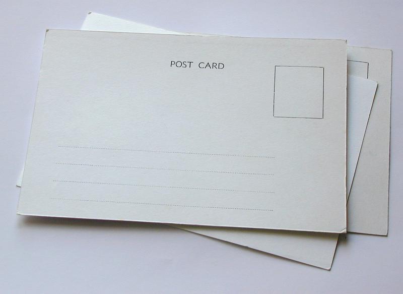 Free Stock Photo: Pile of blank postcard stacked on white showing the reverse side with copy space for a message
