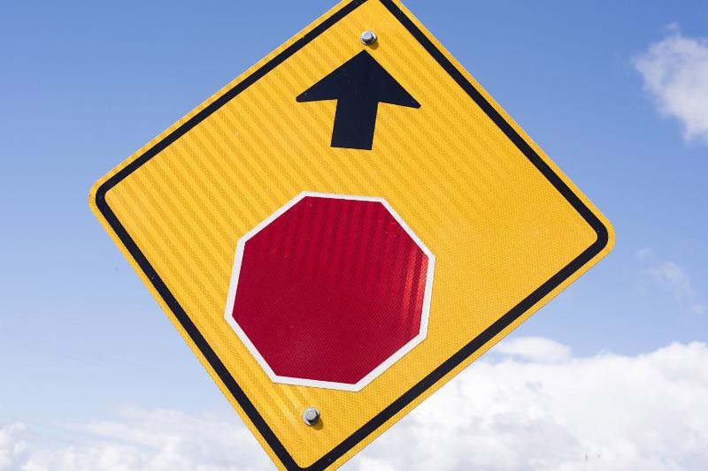Free Stock Photo: Yellow warning traffic sign for a Stop Ahead with forward pointing arrow against a cloudy blue sky