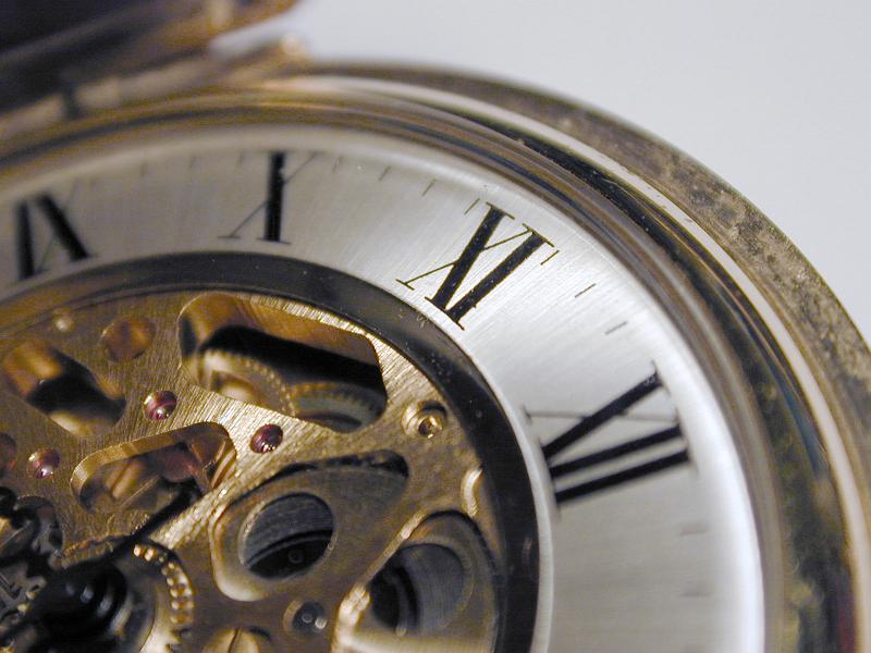 Free Stock Photo: close up on the dial of a brass pocket watch with roman numerals
