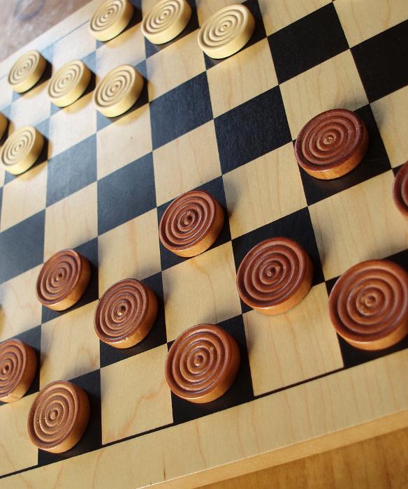 Free Stock Photo: traditional game of strategy: counters on a wooden draughts board