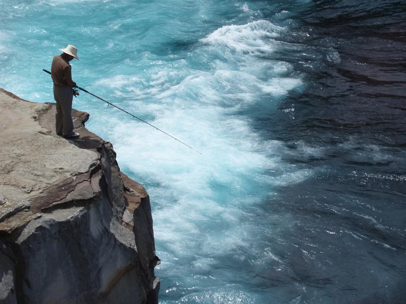 Free Stock Photo: a fisherman stood on a clifftop