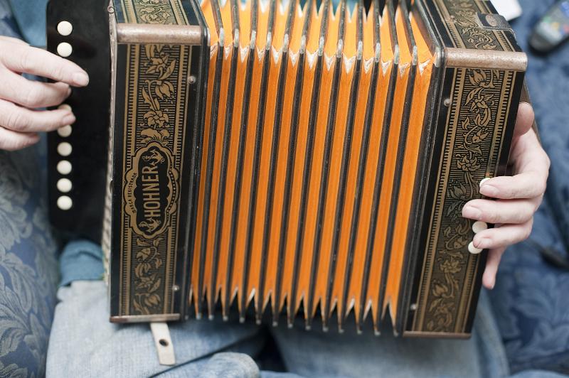 Free Stock Photo: a man playing a squeezebox organ
