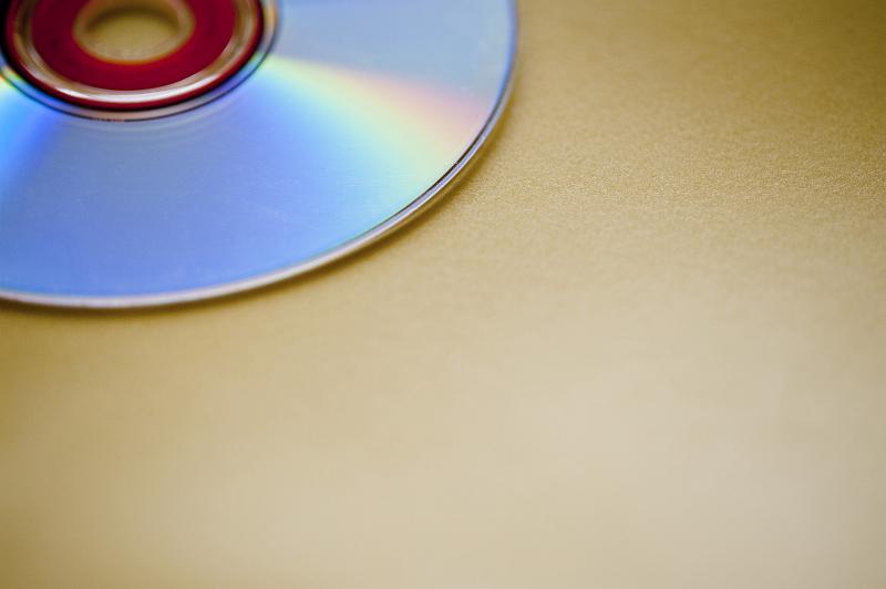 Free Stock Photo: an audio cd resting on a yellow background