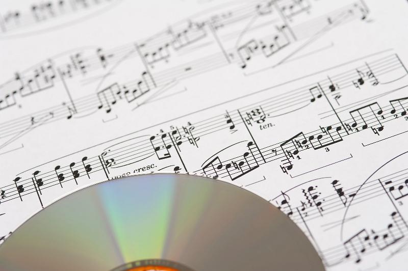 Free Stock Photo: an audio cd on a background of printed sheet music