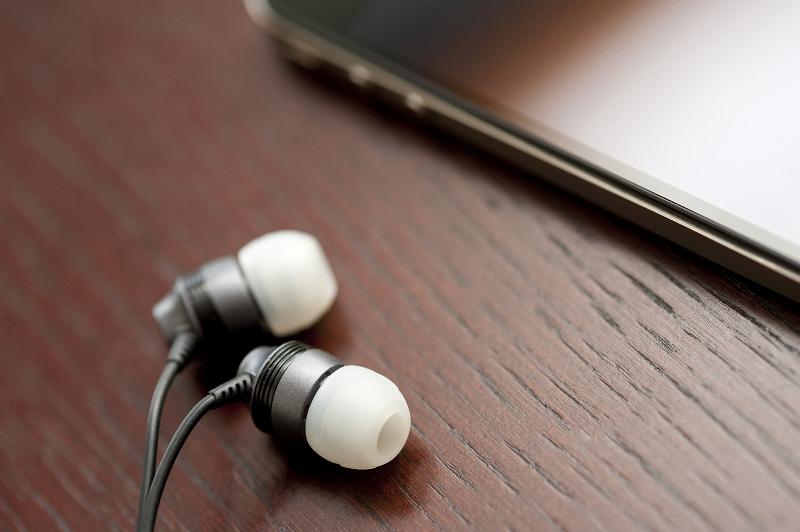 Free Stock Photo: in ear headphones and a mobile phone for listening to music on the move