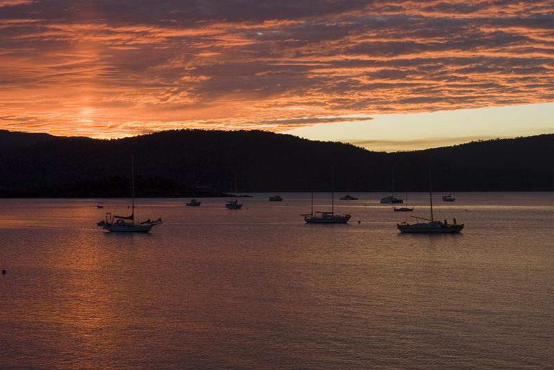 Free Stock Photo: a panoramic view of sailing yachts back lit by beautiful pink orange sunset light