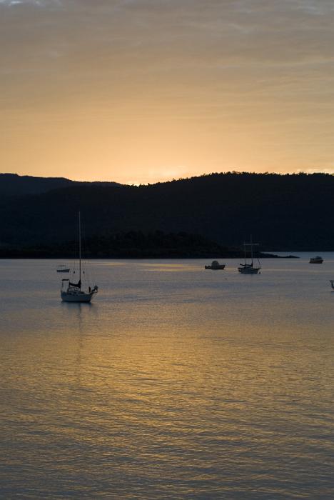 Free Stock Photo: the quietness at sunset looking out across boats on a calm ocean lit by a golden glow