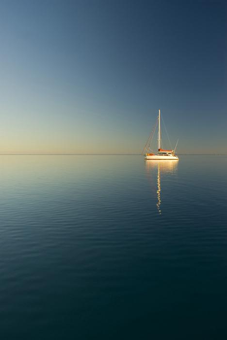 Download image of serene sunset Free Stock Photo: lookout out across still water, a lone yacht moored in a sunset glow