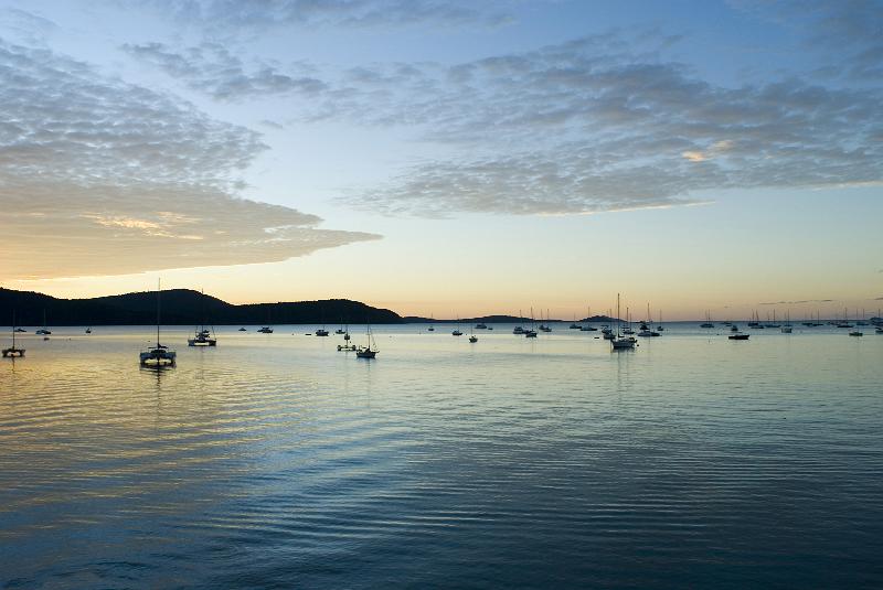 Free Stock Photo: serenity of a still sunset over the water, yachts moored as the sun dissappears below the horizon