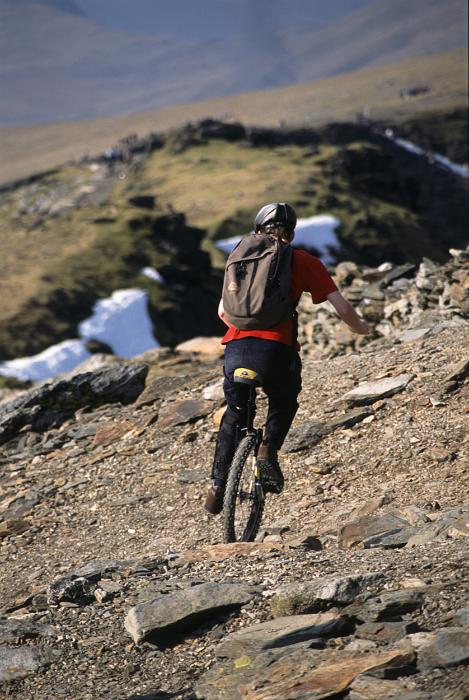 Free Stock Photo: a unicyclist negotiating the side of a mountain