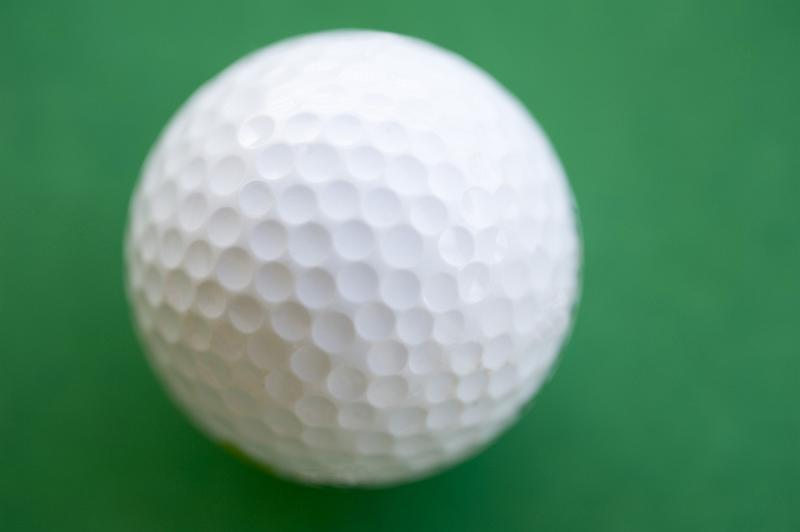 Free Stock Photo: a white golf ball on a green background
